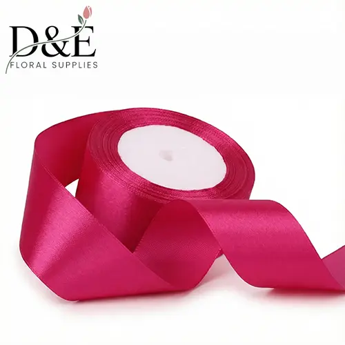 Fuchsia 1.5 inch single face satin ribbon roll on white background