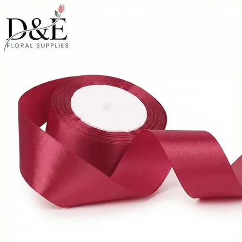 SR-06-burgundy Burgundy 1.5 inch single face satin ribbon roll on white background