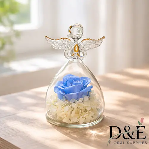Blue preserved rose displayed inside an angel glass bottle