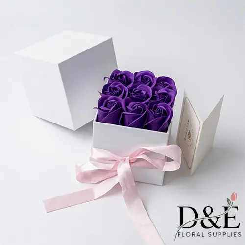 Faux purple roses in small white gift box Small artificial purple roses Mother's Day gift box with pink ribbon