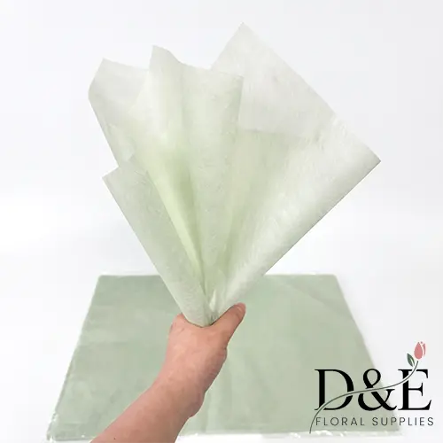 Mint Waterproof Tissue Paper Sheets for Bouquet Wrapping Mint waterproof tissue paper sheets for bouquet and floral wrapping, held in hand.